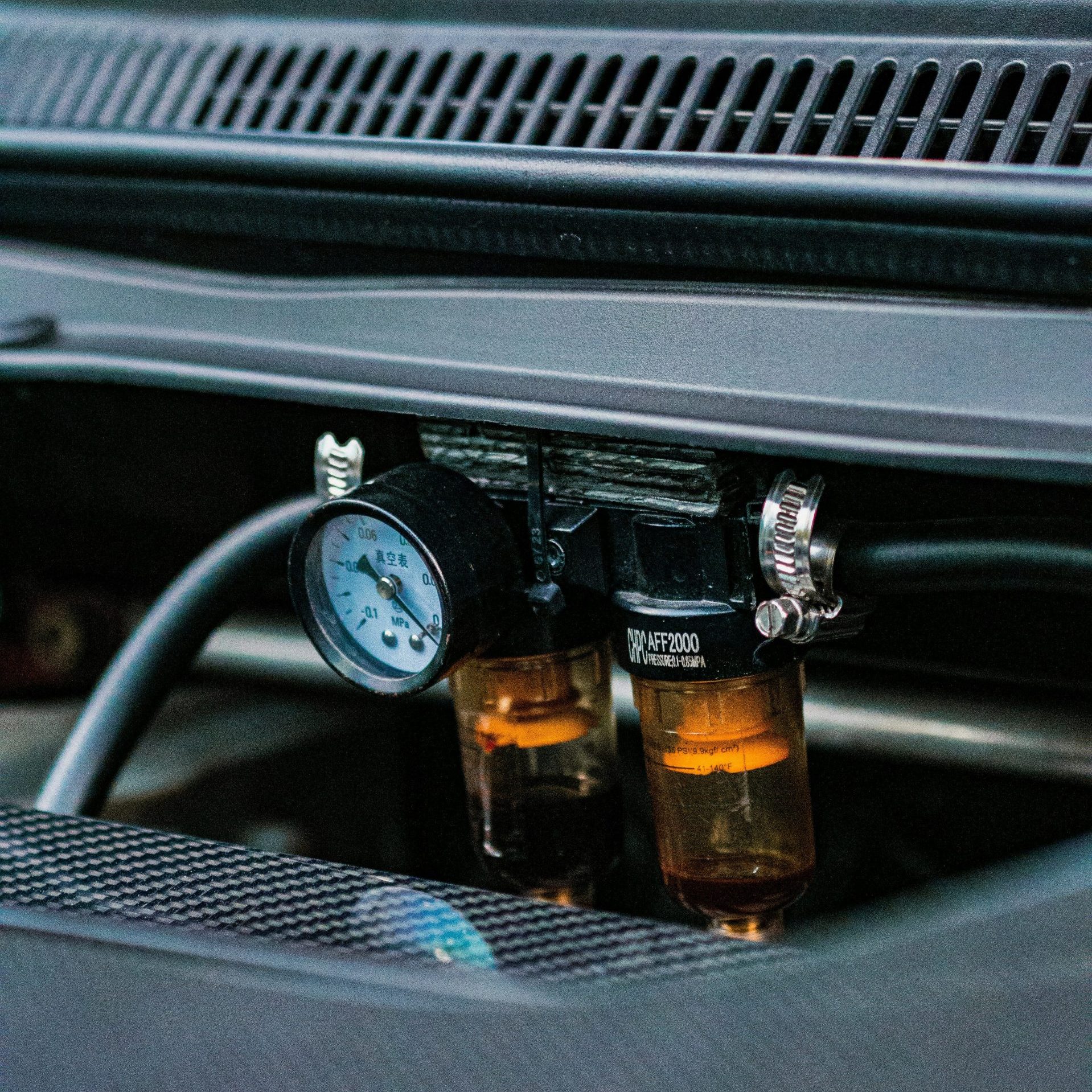 a close up of a car engine with two bottles